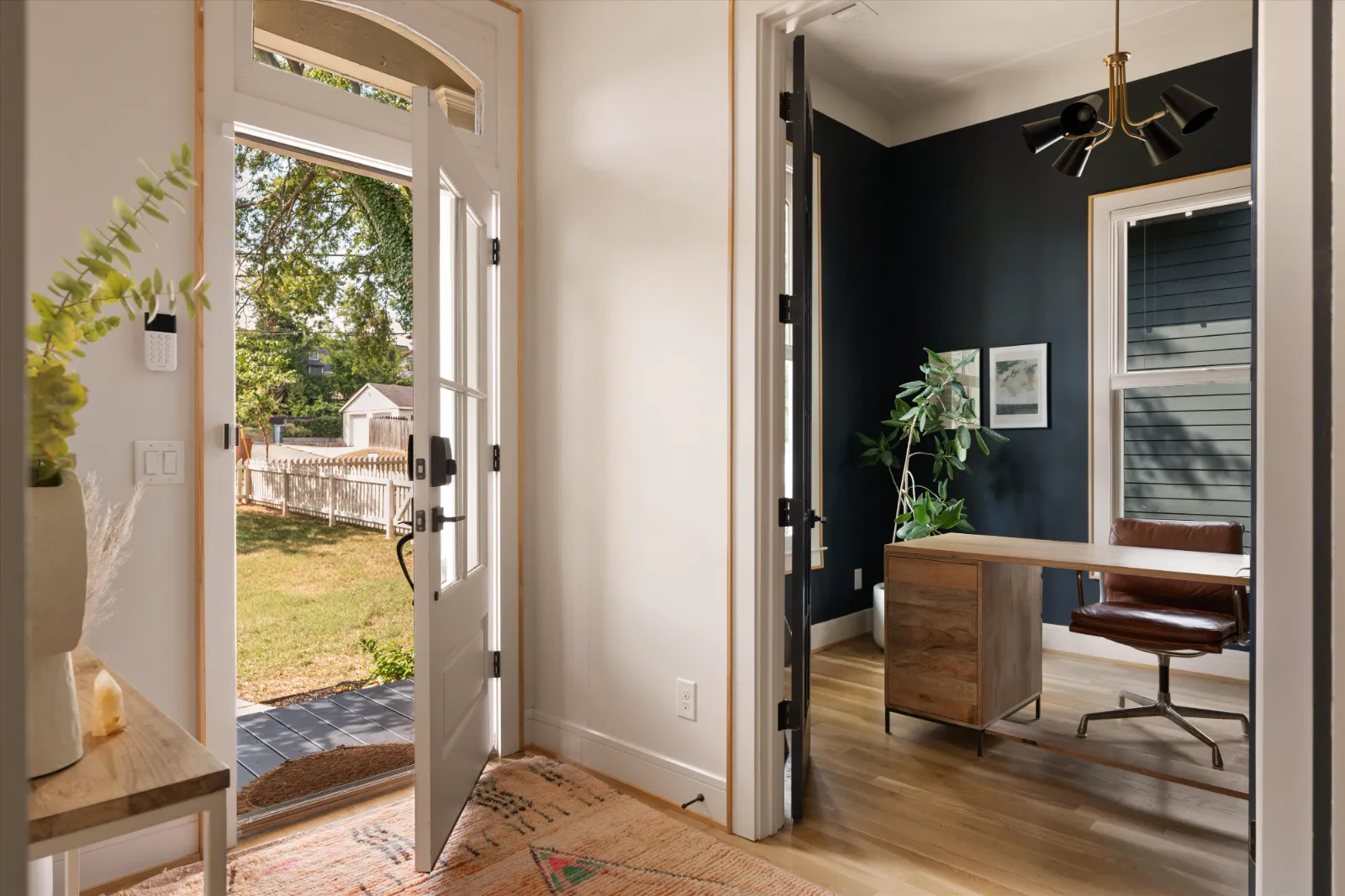 The front door open, the office beyond at right