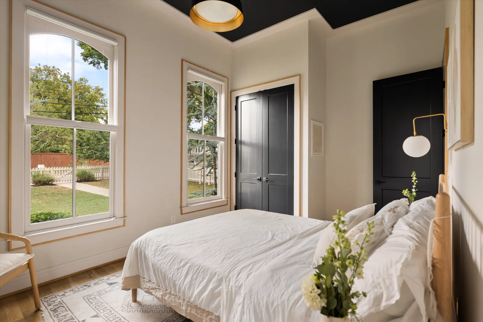 Main-floor guest bedroom with arched windows on two walls