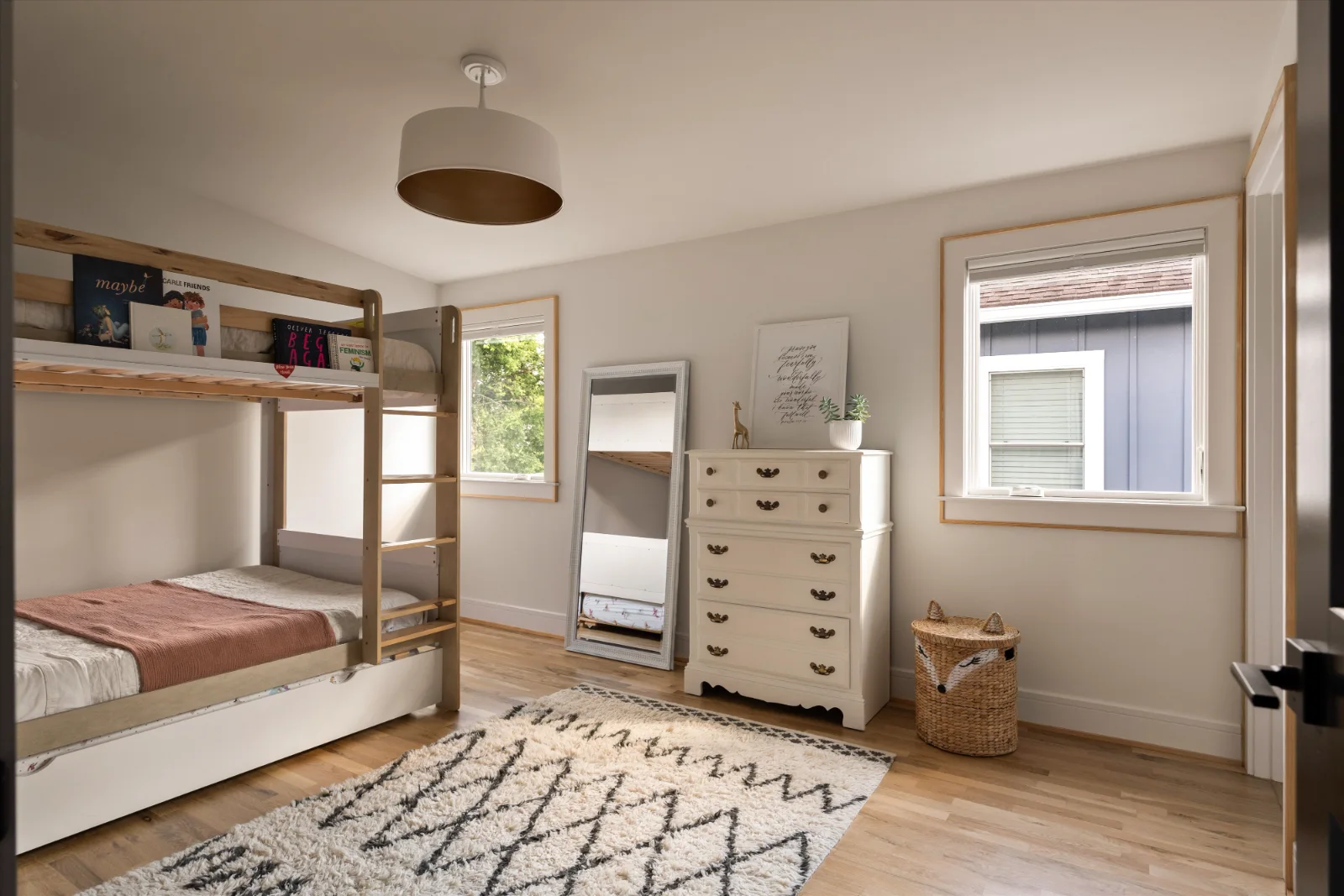 Upstairs bedroom with bunk beds, a trundle and two windows