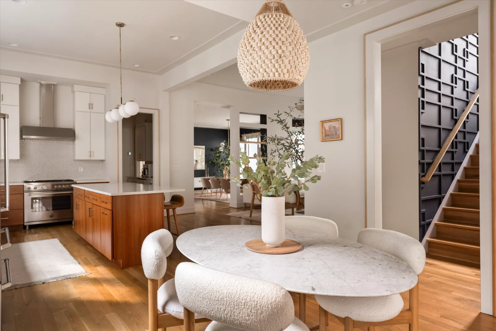 The breakfast table looking back to the kitchen island and the stair