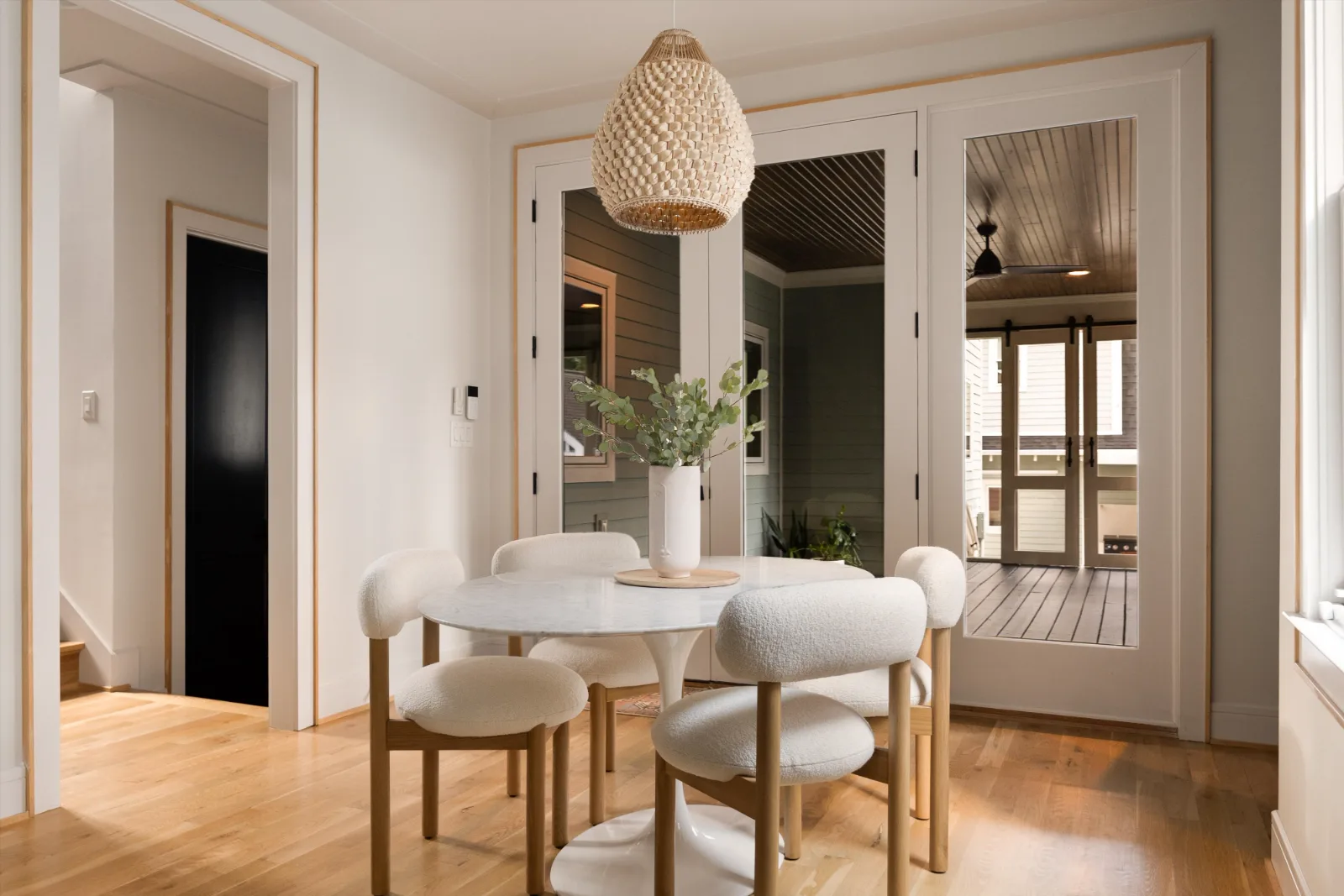 Breakfast room with a round marble table and glass doors to the screened porch