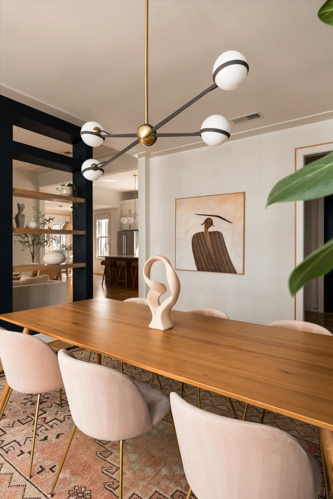 The dining room from the table, the kitchen and island visible through the opening