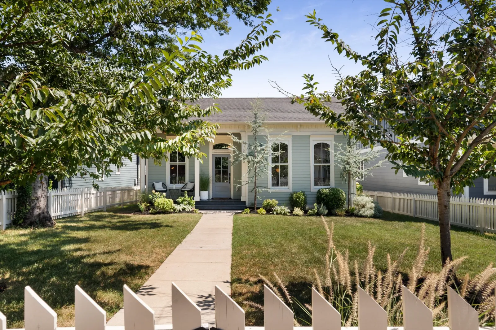 2020 10th Avenue South from the sidewalk, an 1880 house behind a white picket fence