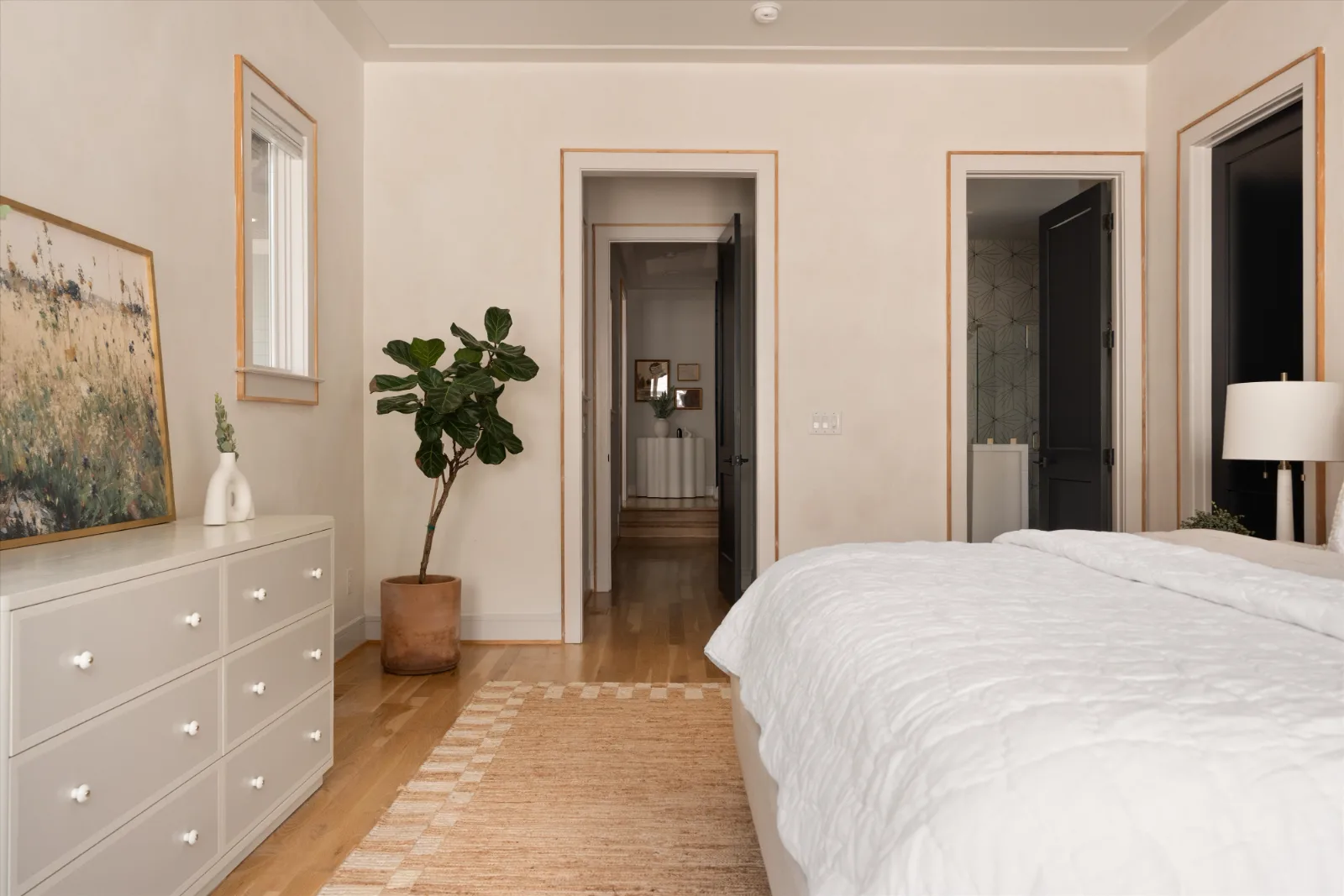 The primary bedroom looking through to the hall and the en-suite bath